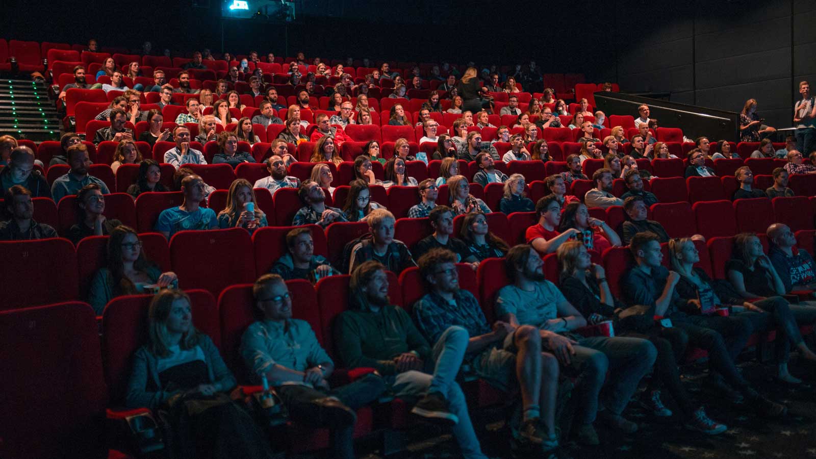 Large group of people watching a film at the cinema.