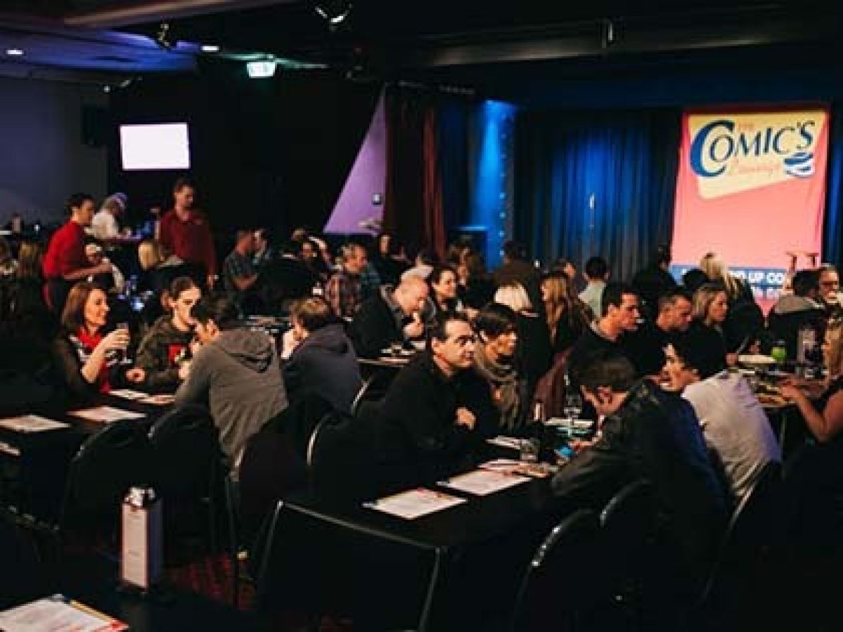 People at the Comics Lounge sitting at tables, enjoying a show.