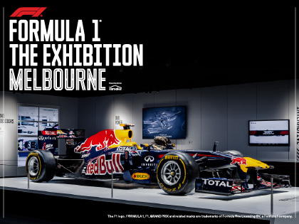 An F! car displayed on stage in an exhibition. 