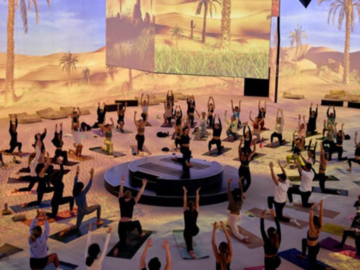 A group of people doing a yoga class in the Lume Melbourne. 