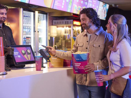 A couple buying popcorn from the snack bar