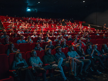Large group of people watching a film at the cinema.
