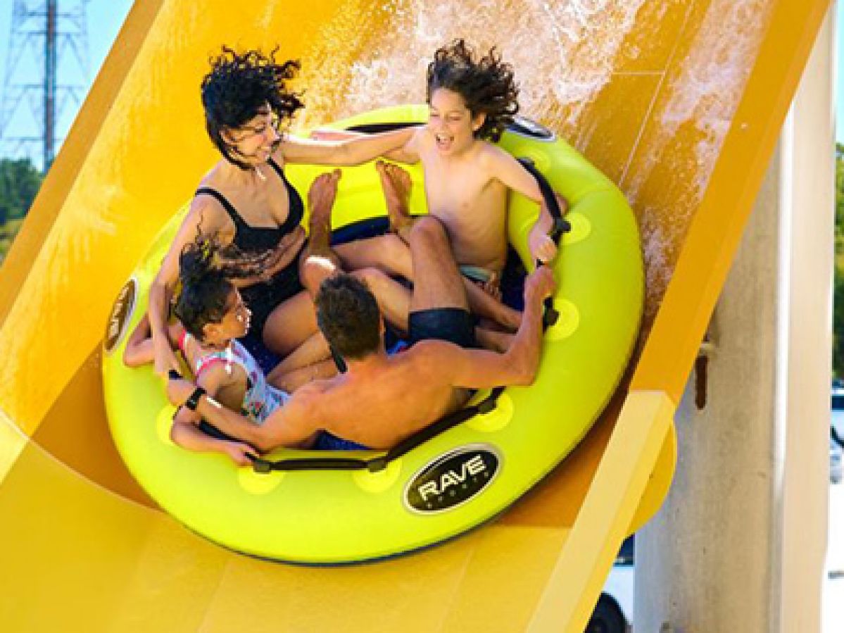 Family in a yellow ring going down a waterslide. 