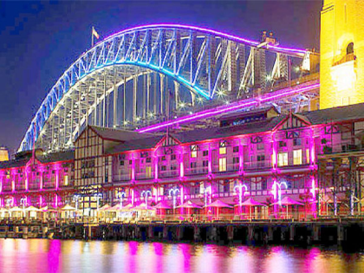 Sydney Harbour Bridge lit up at night.