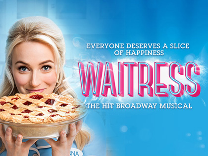 A blonde woman holding a pie. 