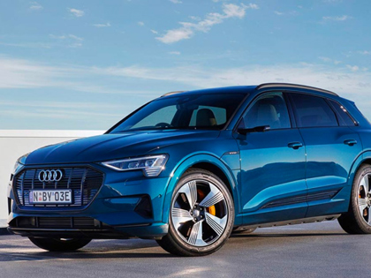 A blue Audi electric vehicle parked in an open space.