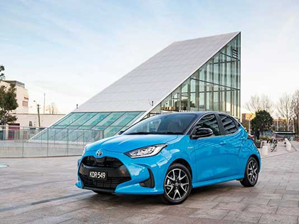 A blue Toyota Yaris parked on a rooftop.