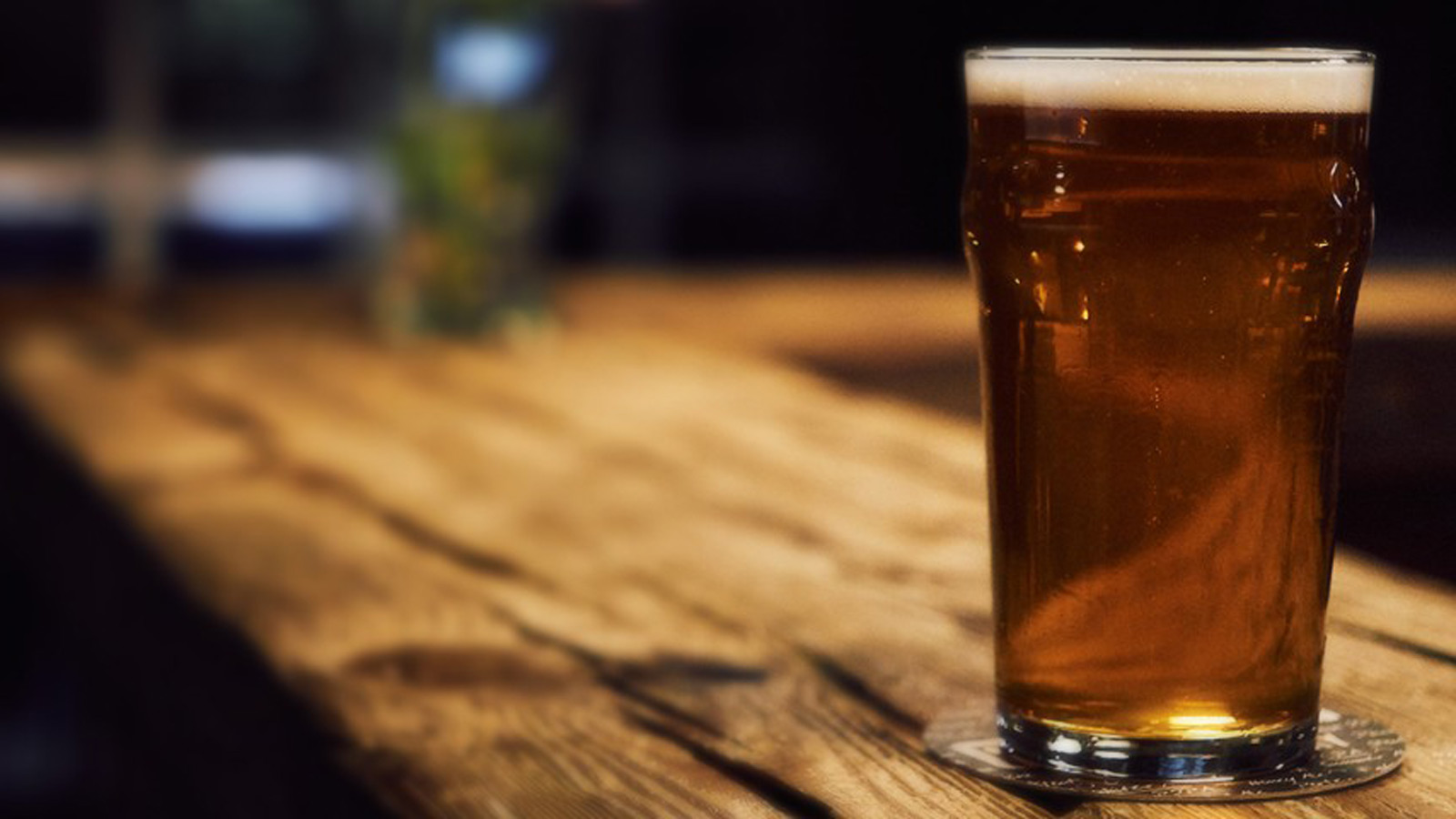 Glass of beer on a counter.