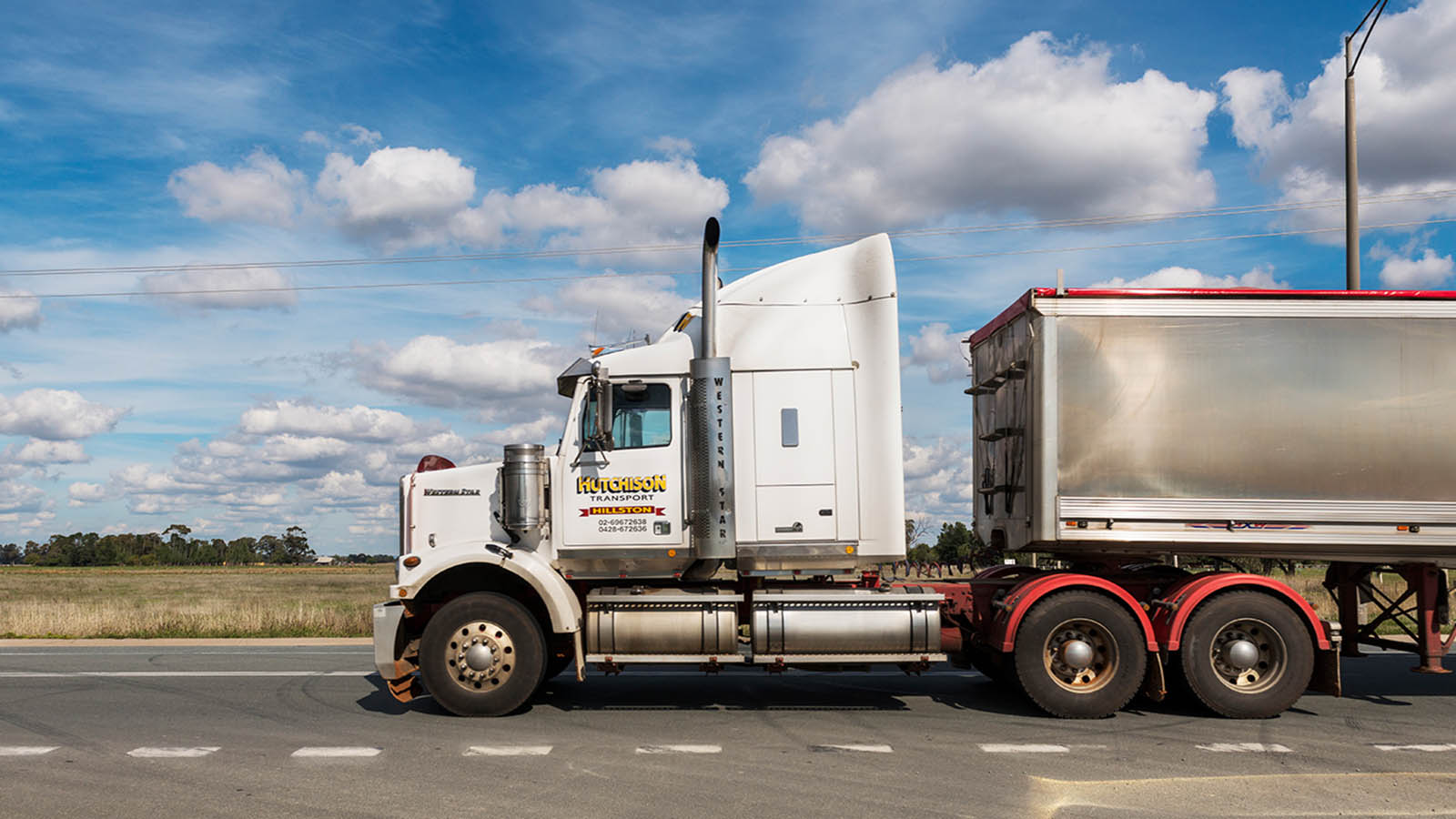 Truck on a highway on a sunny day.