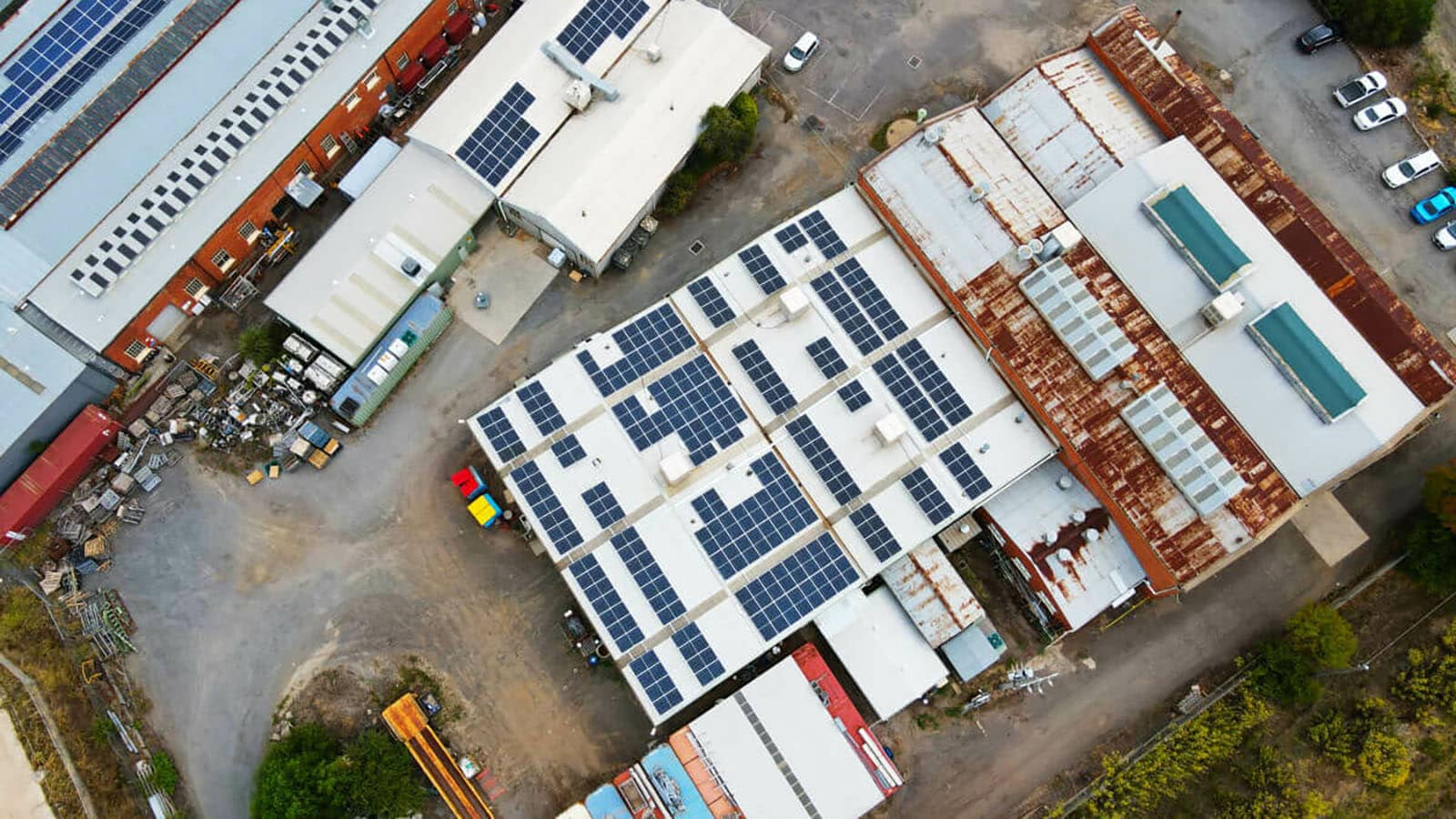 Aerial image of historic Bendigo Woollen Mills factory with solar panels on roof.