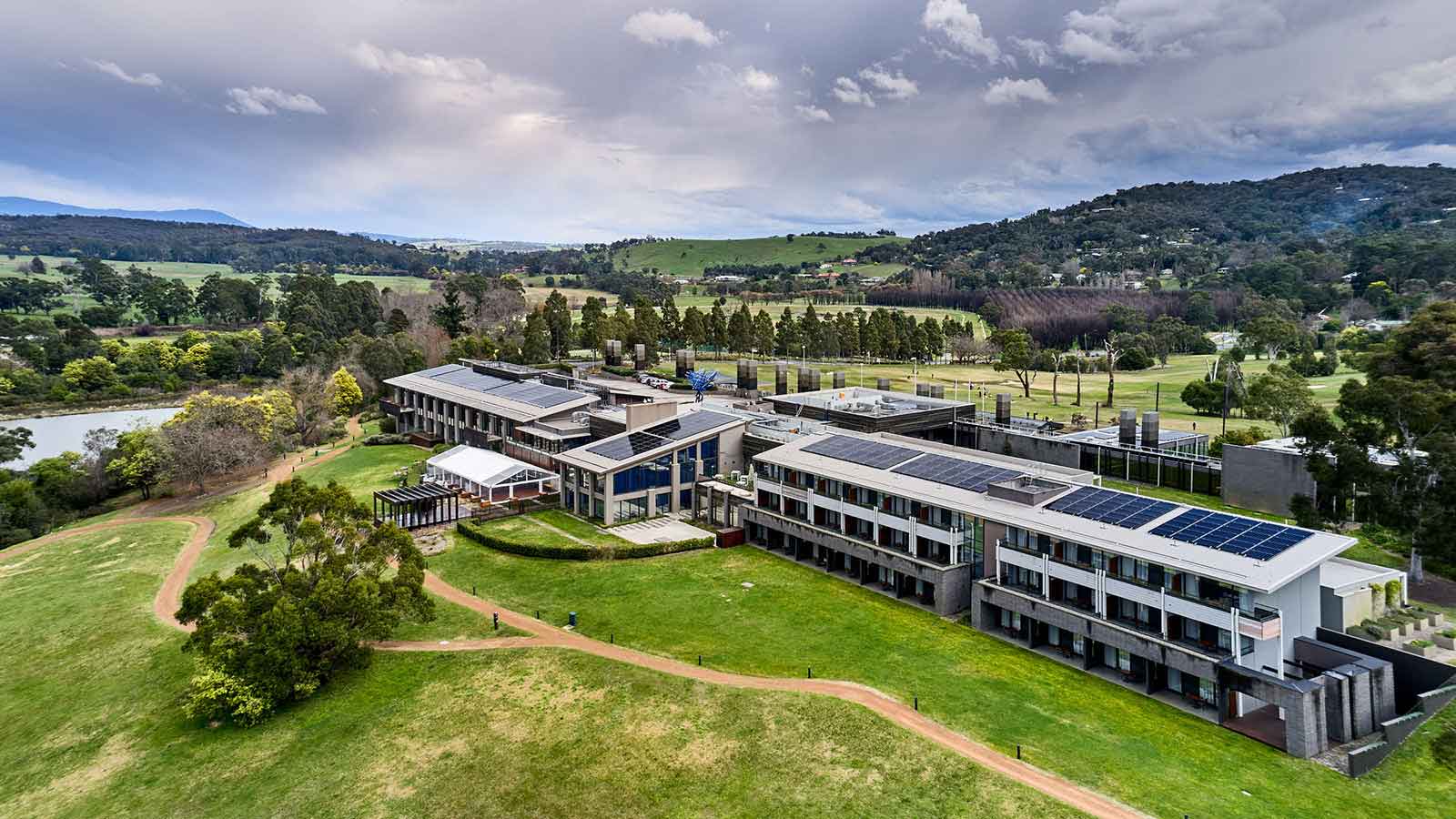 Aerial view of RACV Healesville solar panels and surrounding lush, green grounds.