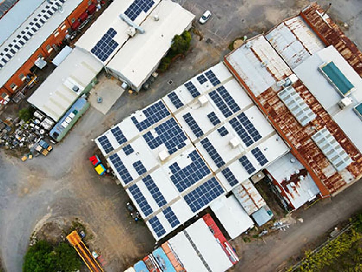 Aerial photo of historic Bendigo Woollen Mills factory with solar panels on roof.