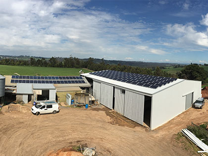 Aerial view of a shed fitted with solar panels. 