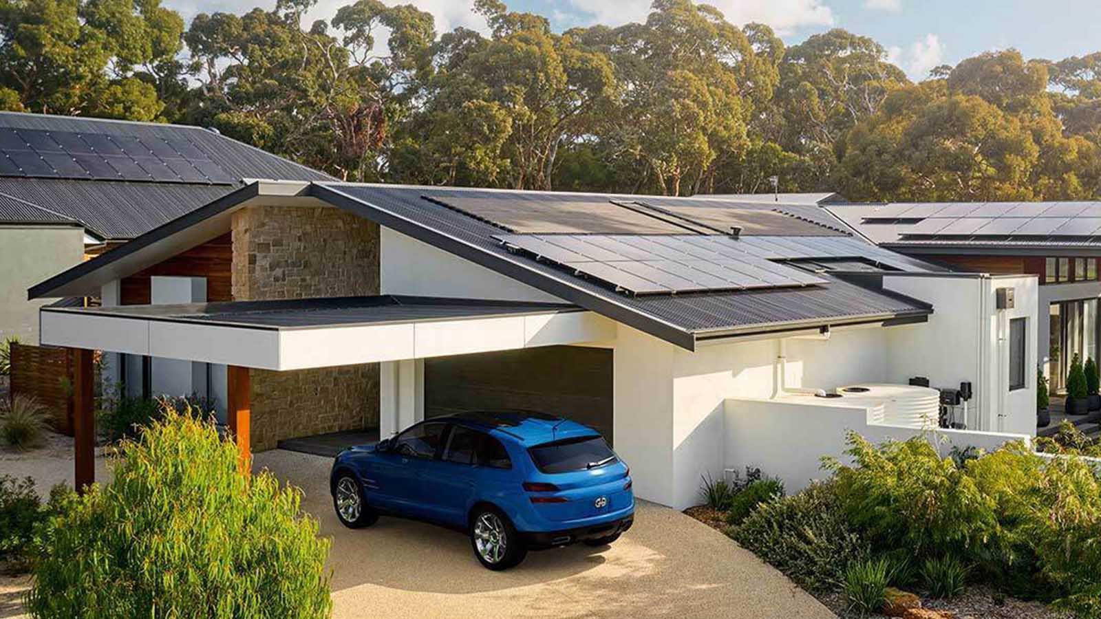 Residential home in Ocean Grove with solar panels on the roof, blue car parked in driveway.