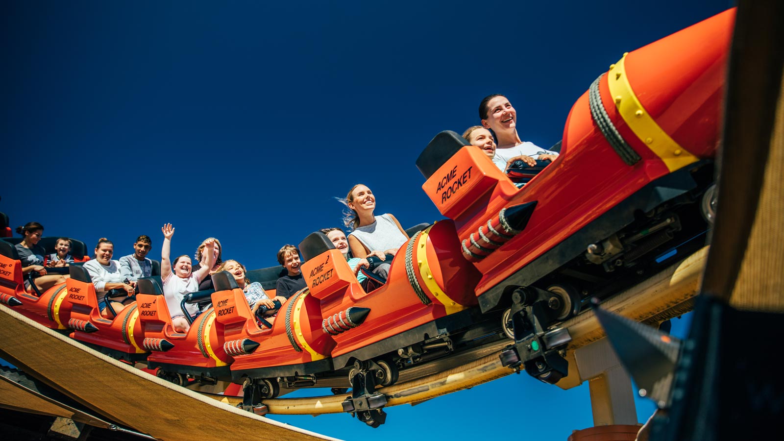 A group of people riding a rollercoaster at Movie World