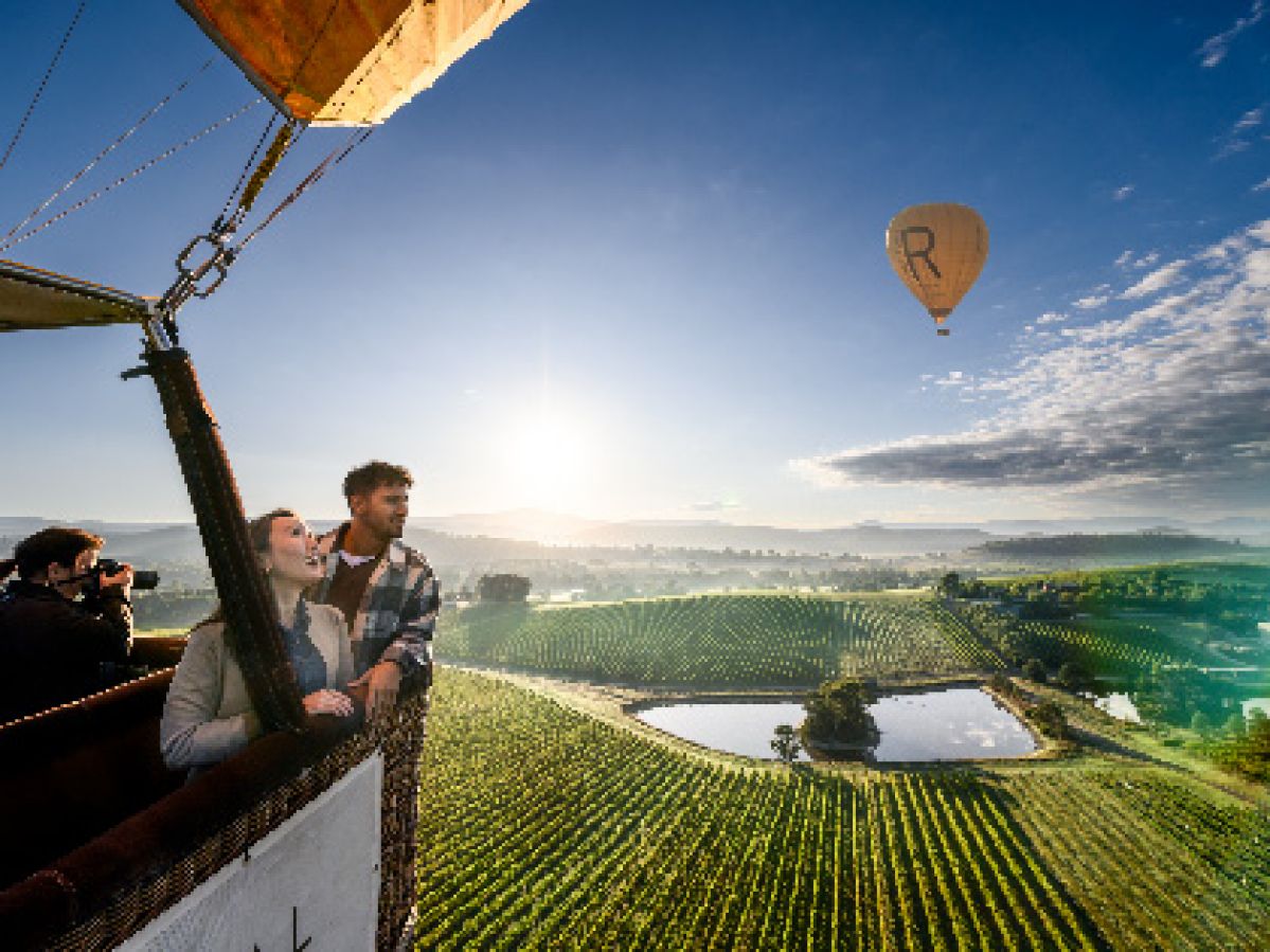 A couple riding in a hot air baloon over the Yarra Valley