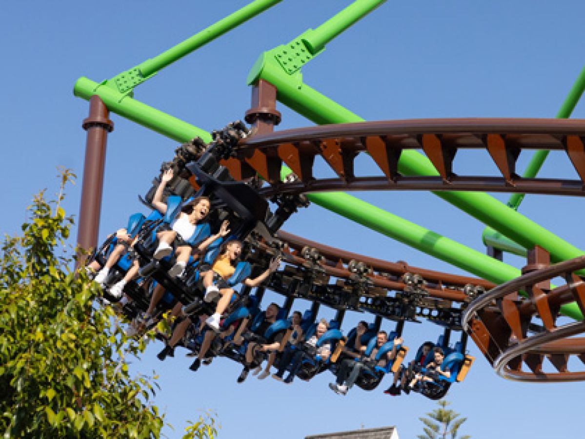 People cheering as they ride on a roller coaster