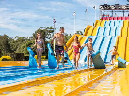 Family walking off the end of a water slide together