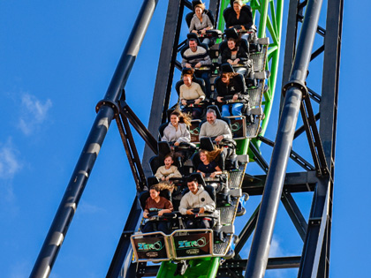 People riding a roller coaster at Gumbaya world
