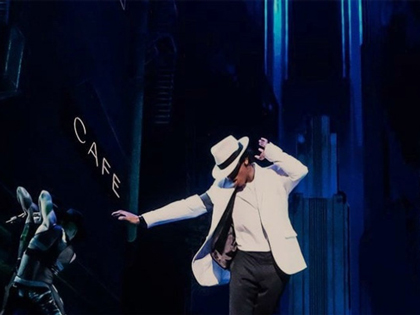 A michael Jackson impersonator dancing on stage