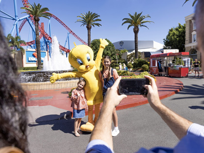 Two children having a photo with Tweety Bird at Movie World.