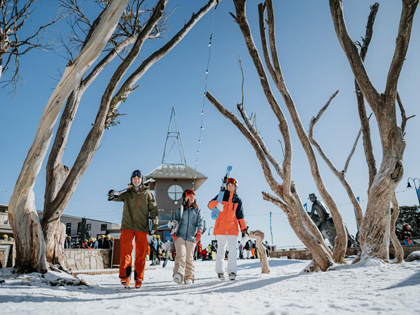 People with ski equipment at Mt Buller