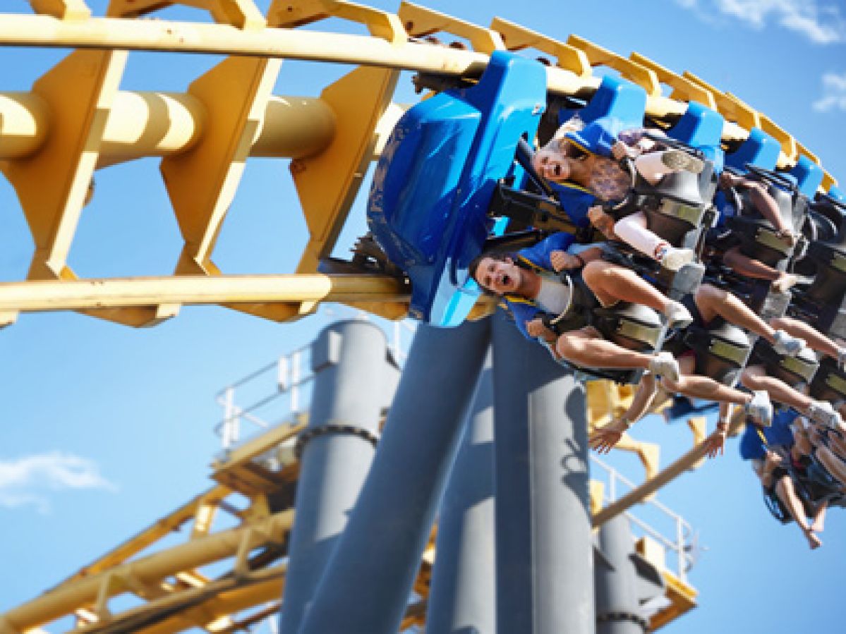 People riding roller coaster
