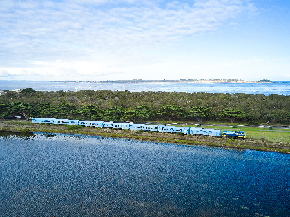 The Q train going past a lake. 
