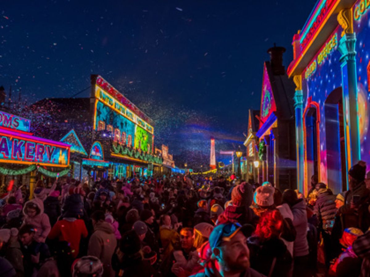 The night lights shining at Sovereign Hill with large crowds gathered to enjoy them. 