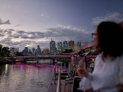 Woman having a drink by the Yarra