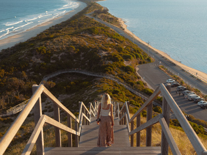 Woman standing on the neck at Bruny Island