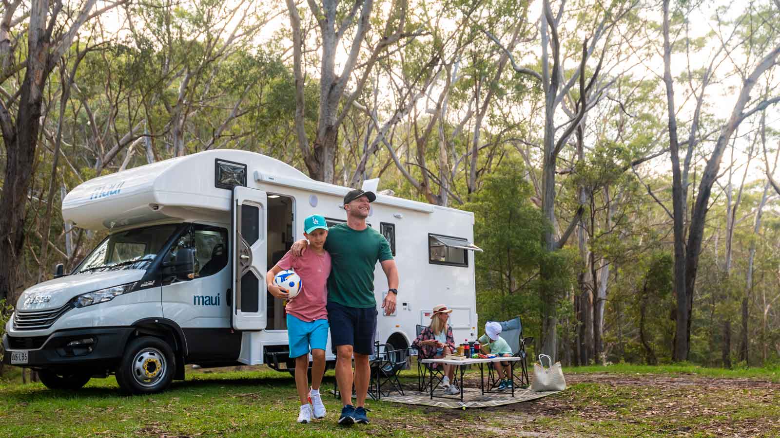 A young family enjoying the outdoors near the campervan.