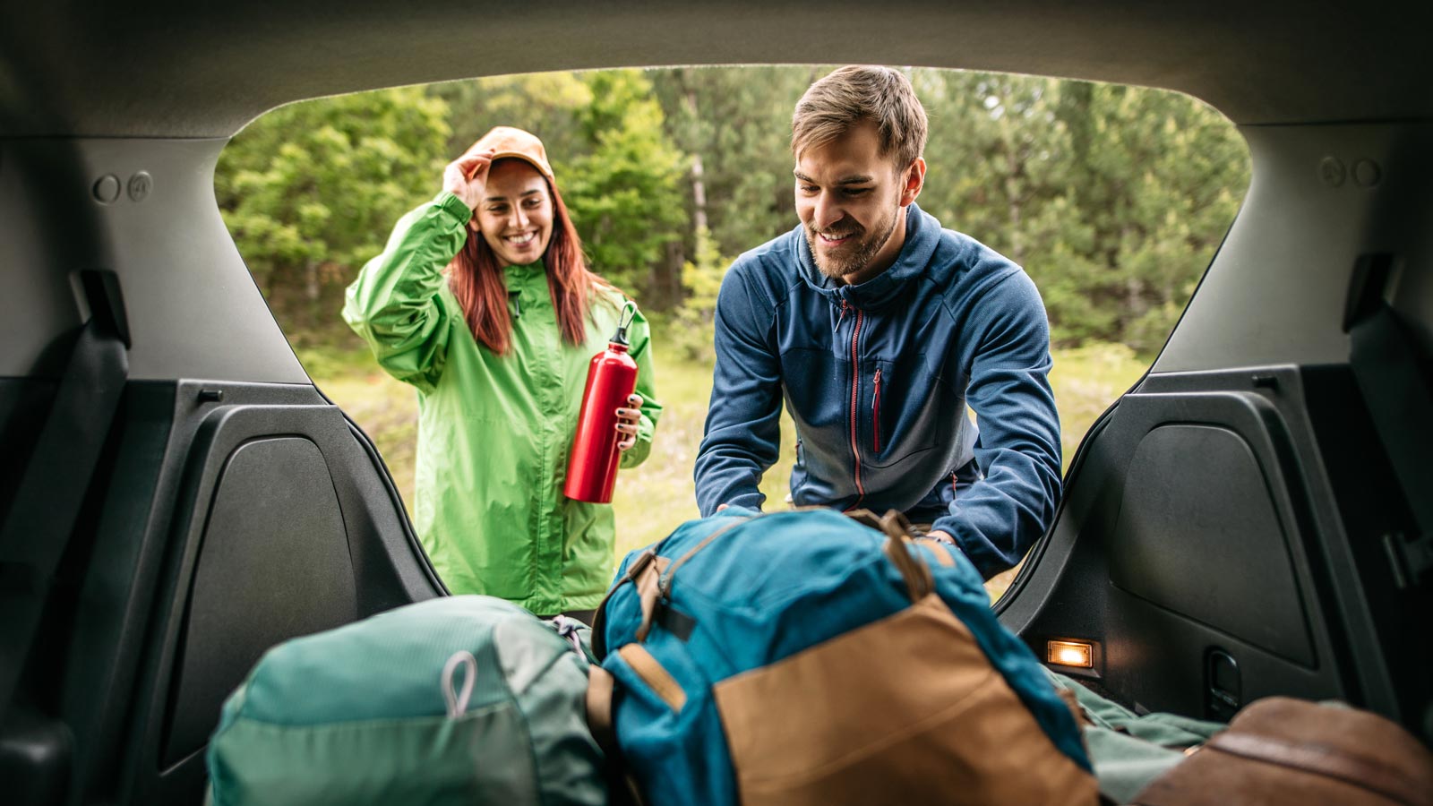 Couple loading bags into the car