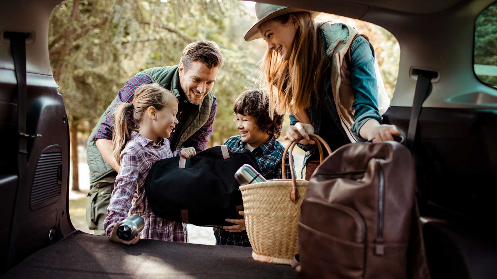 Young family packing the car together.