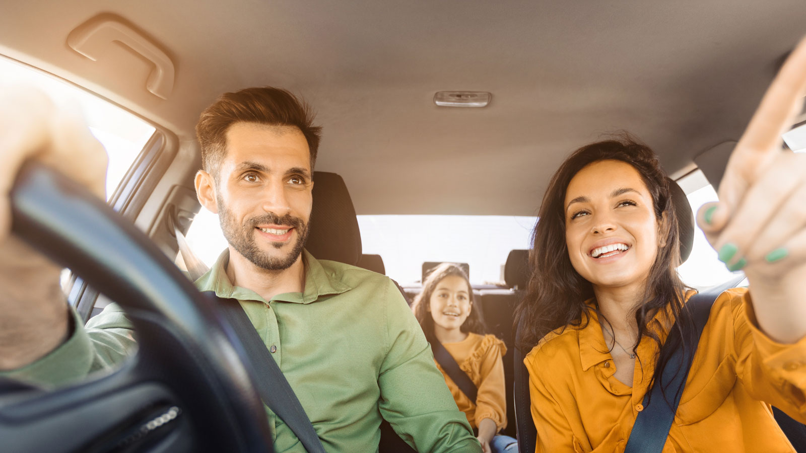 A young family in a car from the view of the windscreen. 