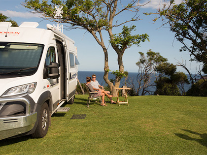 Couple sitting outside at an NRMA caravan park.