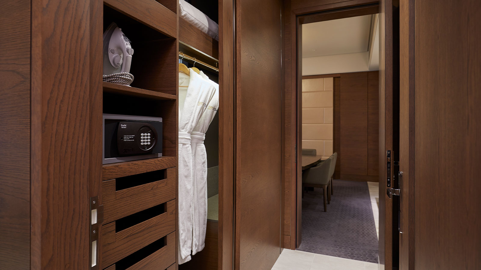 City club family suite wardrobe space including robes and a safe. 