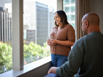 A couple enjoying the view from the windows atr City Club