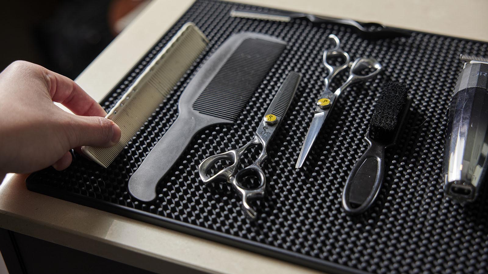 A flat lay of combs and scissors that a barber would use.