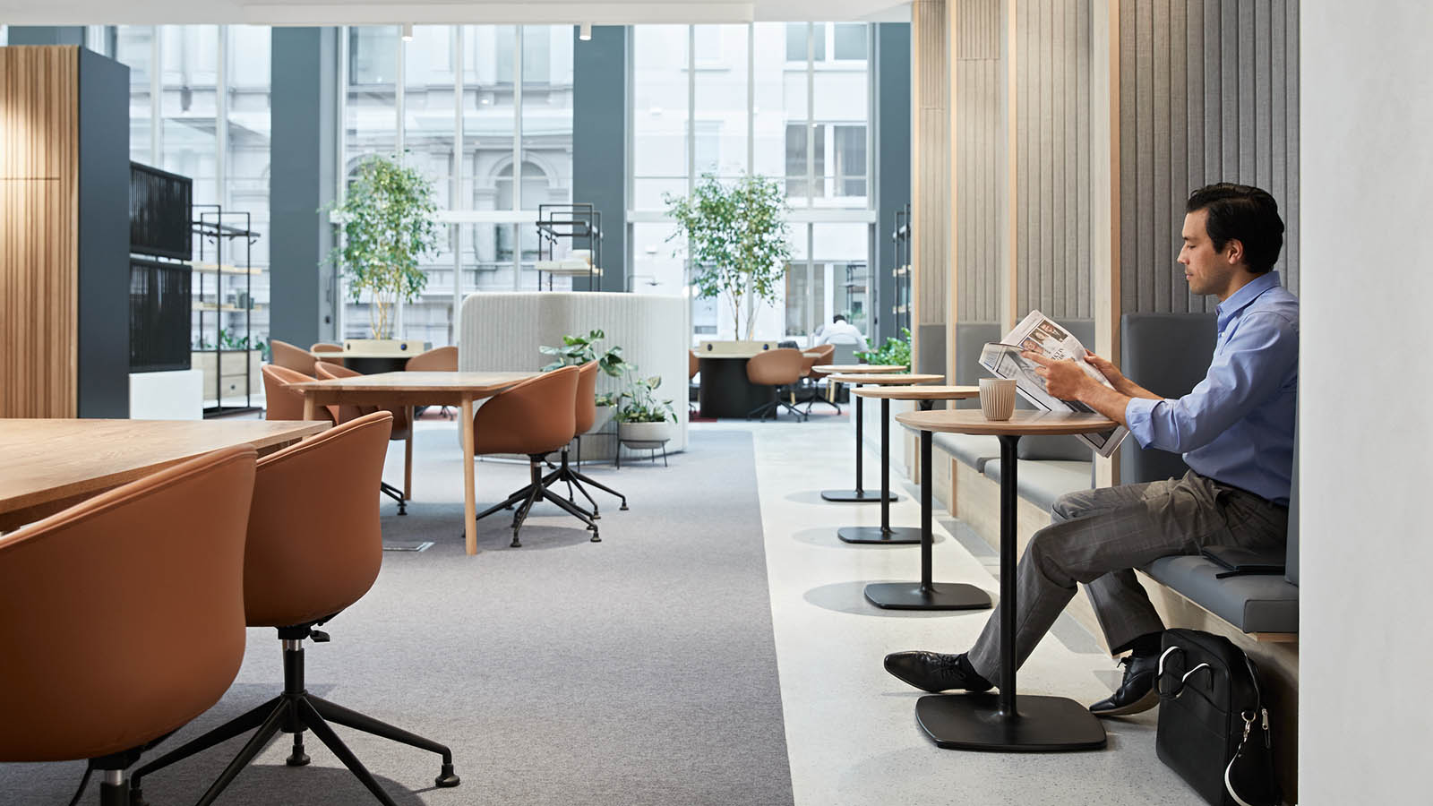 Person sitting at a desk and reading in the RACV City Club business centre.