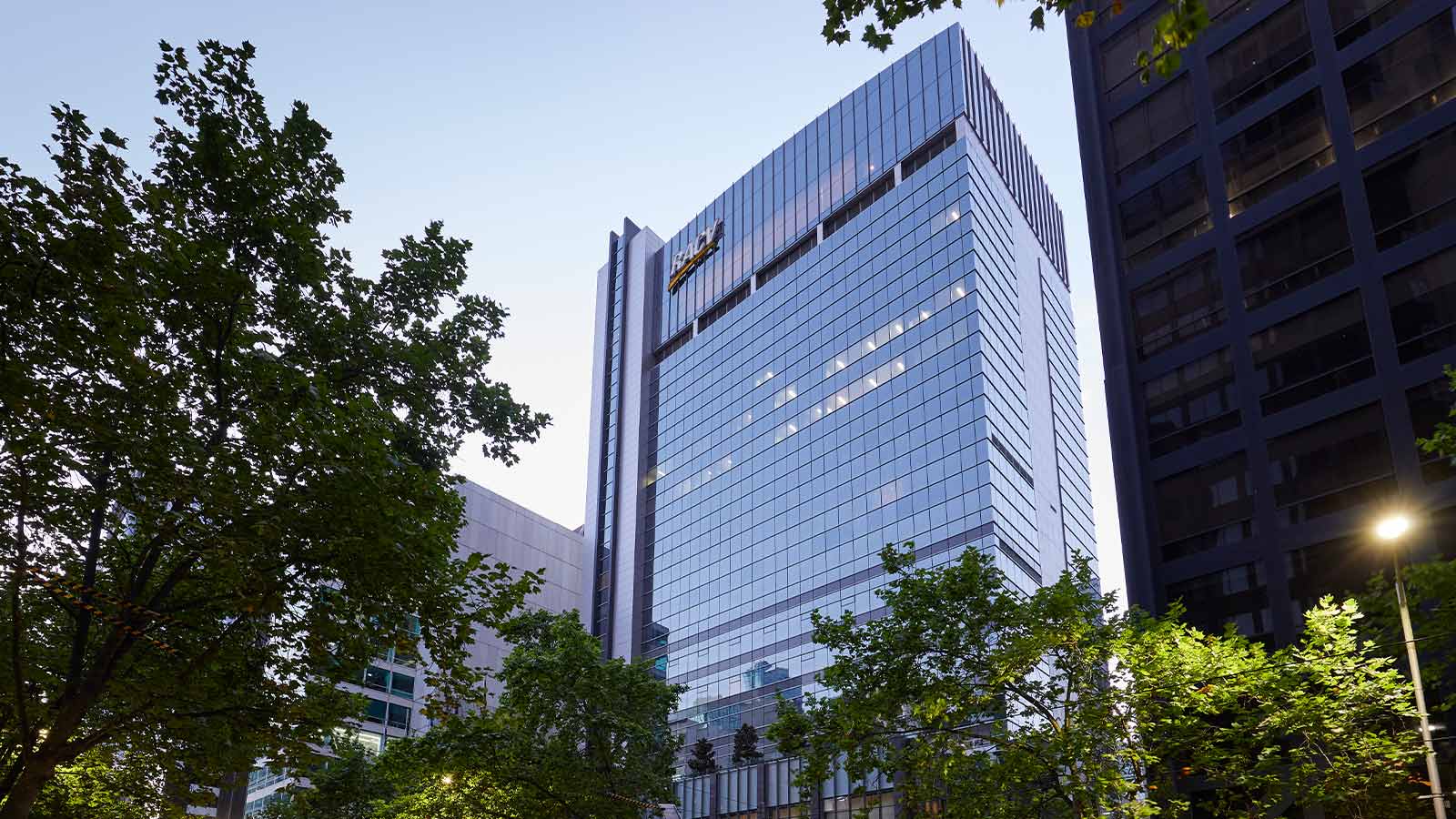 Exterior shot of the RACV City Club with a tram passing.