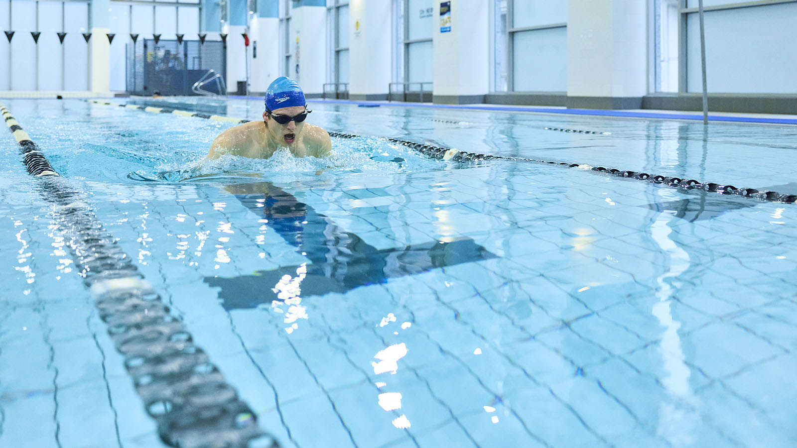 A man swimming in the indoor pool at RACV City Club.