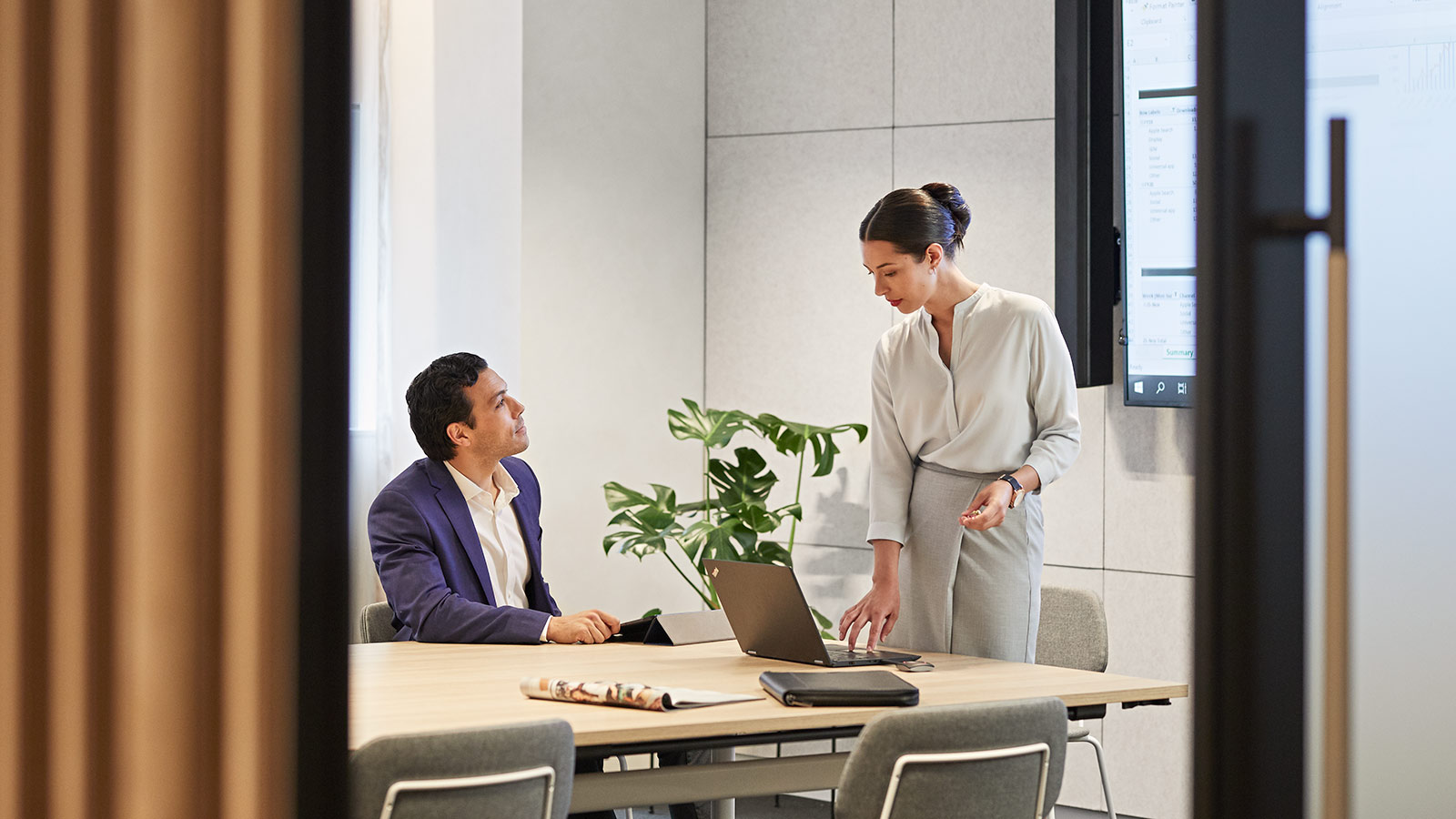 Two professionals having a meeting in a Shared Workspace meeting room at RACV City Club.