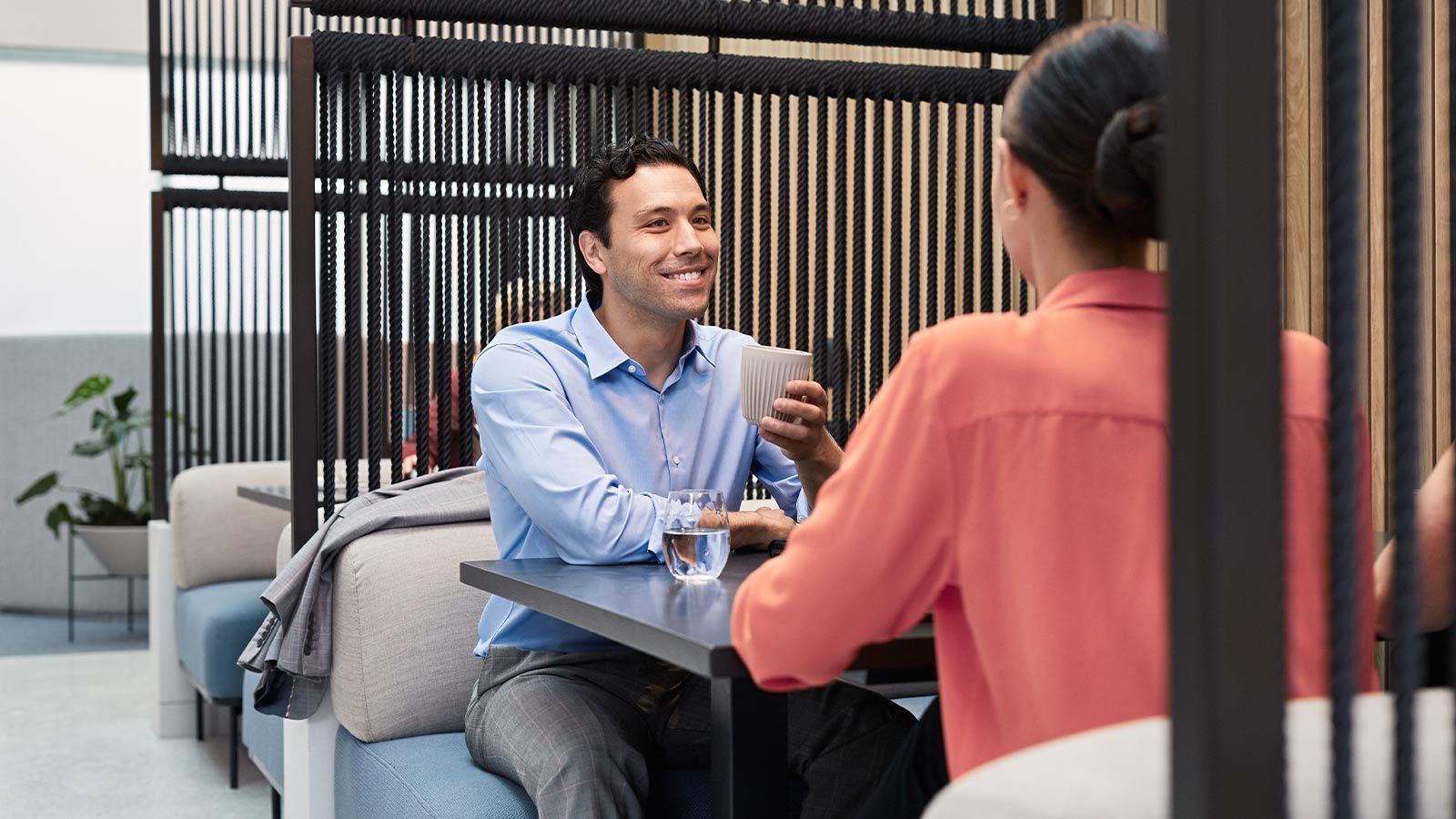 Man and woman having a coffee in the shared work space.