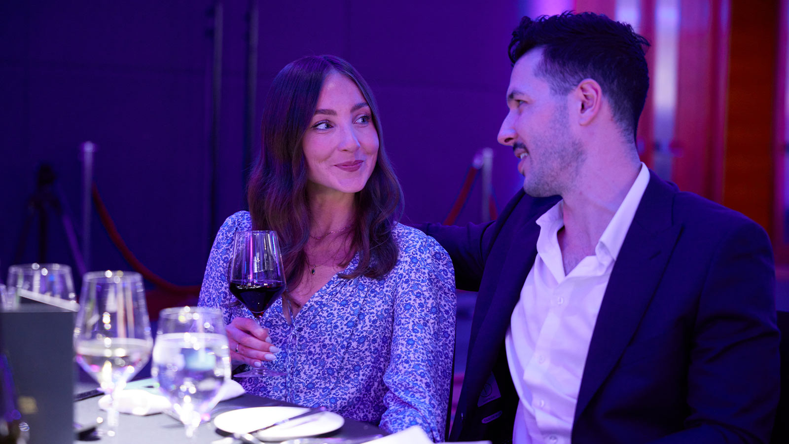 Couple smiling at each other while dining at the chef showdown.