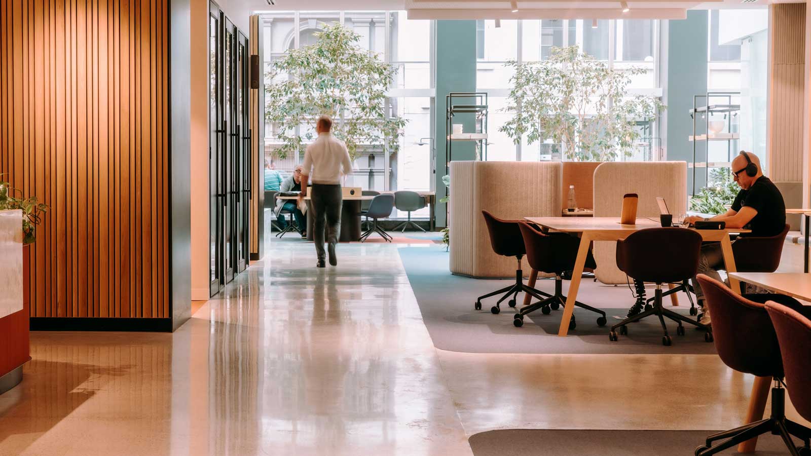An open space leading to large windows and shared seated areas. 