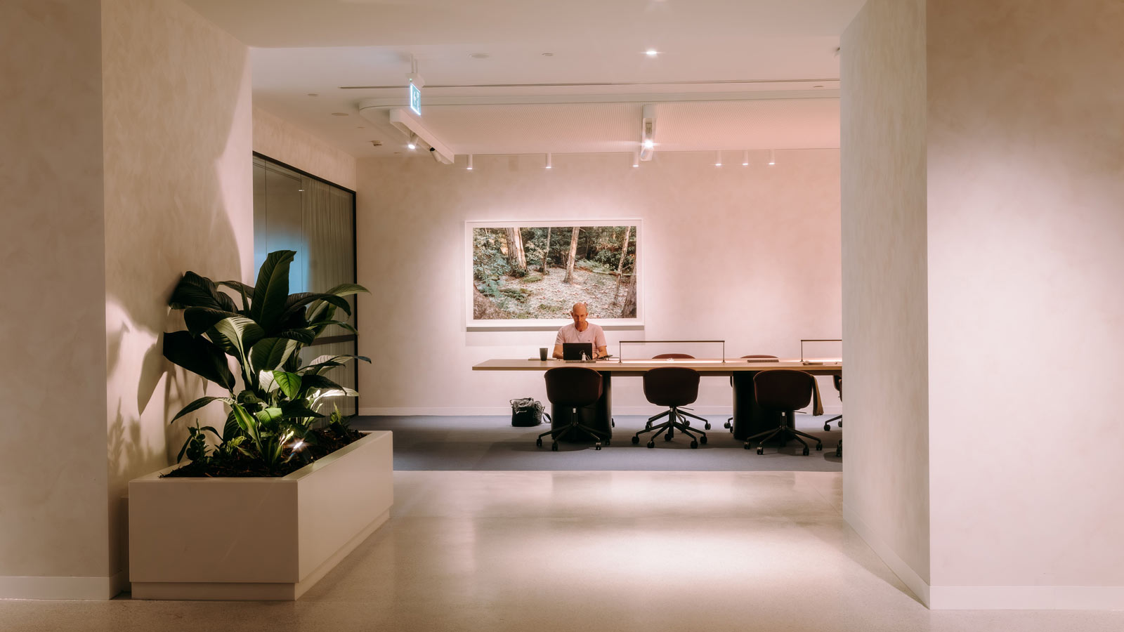 A clean hallway space leading to shared desks.