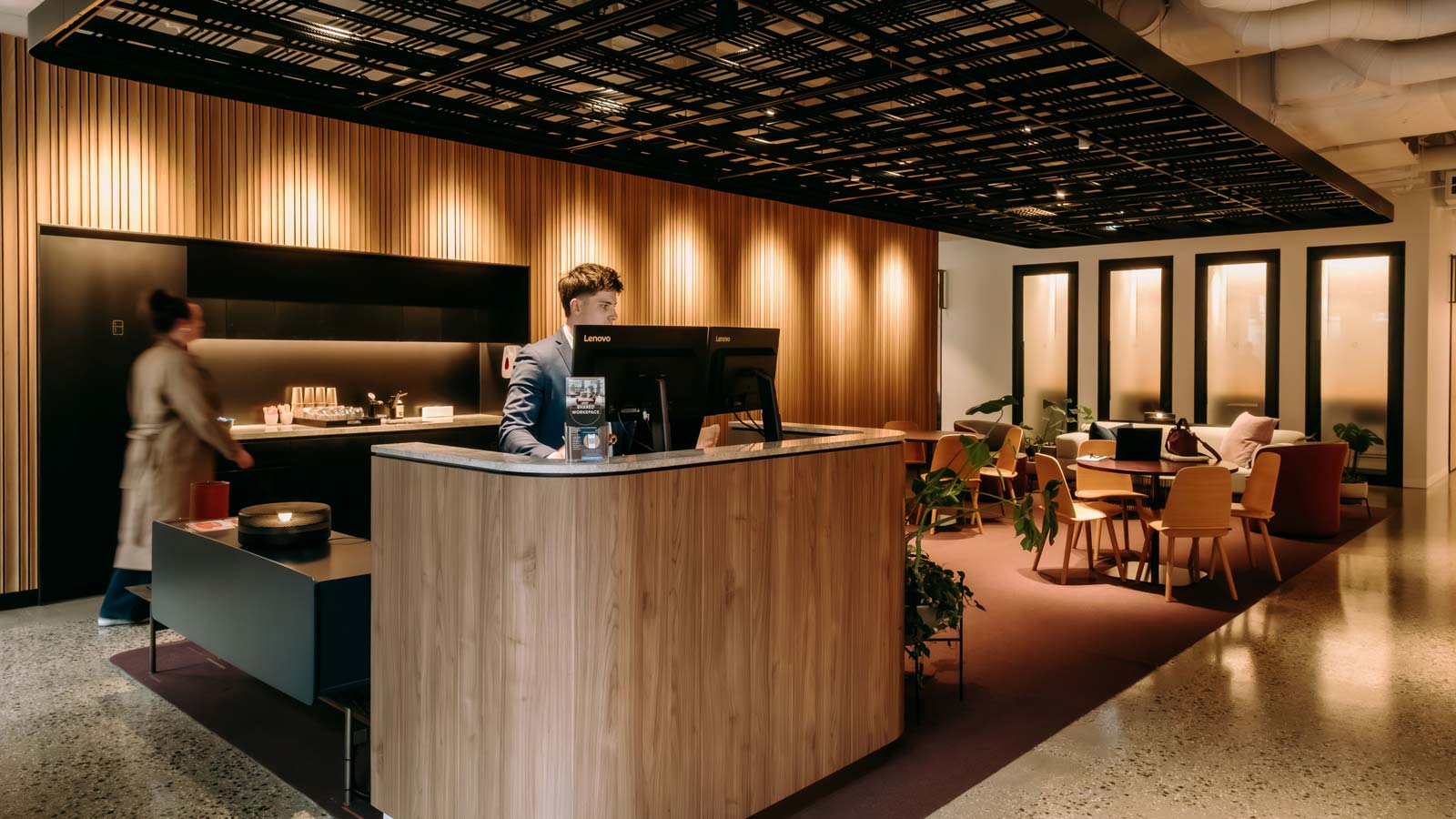 A person manning the reception desk at the shared work space. 