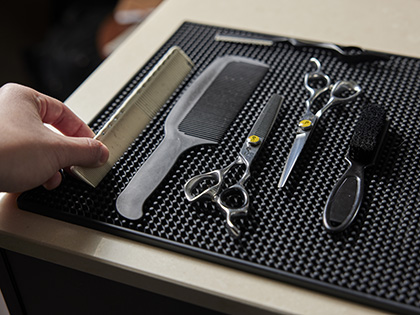 A flat lay of combs and scissors that a barber would use.
