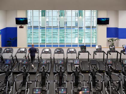 Numerous treadmills overlooking the swimming pool at the City Club fitness centre.